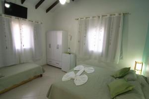 Cama ou camas em um quarto em Pousada Irashai