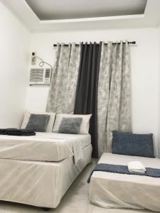 Postel nebo postele na pokoji v ubytování Bolinao Transient House B + 37 fotografií