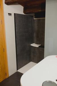 a shower with a glass door in a bathroom at Posada Miranda in Miranda del Castañar