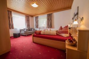 a large room with a bed and a couch at Haus Larcher in Neustift im Stubaital