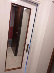 a door with a mirror in a room at RIVERSIDE DA PO 9 Appartamenti ai piedi della collina e vicino al Po in Turin