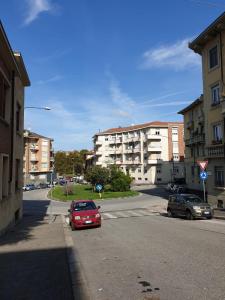 a red car parked on the side of a street at RIVERSIDE DA PO 9 Appartamenti ai piedi della collina e vicino al Po in Turin