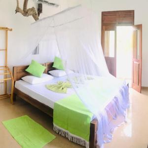 um quarto com uma cama e uma rede mosquiteira em Nalaka Relaxing Home em Weligama