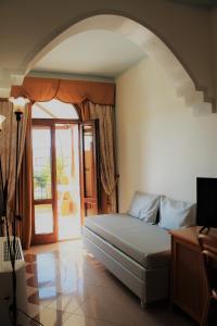 a bedroom with a bed in a room with a window at Hotel Medusa in Lampedusa