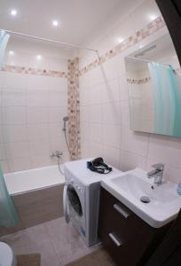 a bathroom with a washing machine and a sink at Apartment Třída Míru in Pardubice