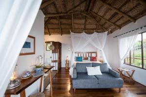 a bedroom with a bed and a couch at Sava Dunes in Miramar