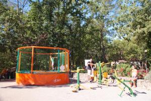 un grupo de personas jugando en una jaula en un parque en Camping Le Parc en Saint-Paul-en-Forêt