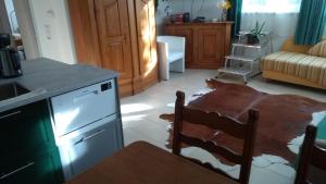 a kitchen with a wooden table and a kitchen with a tableablish at Landhaus ELisabeth in Obereching