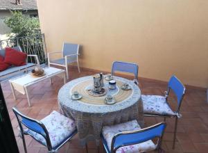 a table and chairs on a patio with a tea set at House Mare e Monti by Holiday World in Albenga