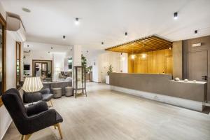 a lobby with two chairs and a reception desk at Palladium Hotel in Kriopigi