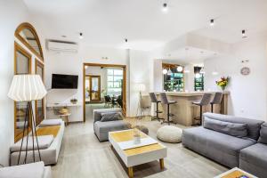 a living room with a couch and a table at Palladium Hotel in Kriopigi