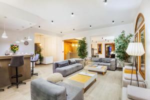 a large living room with couches and a table at Palladium Hotel in Kriopigi