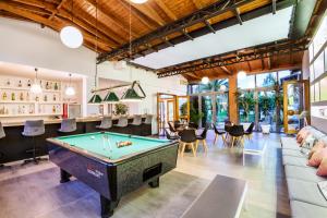 a living room with a pool table in it at Palladium Hotel in Kriopigi