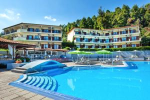 a swimming pool in front of a hotel at Palladium Hotel in Kriopigi