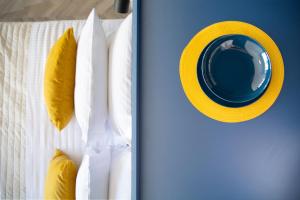 two pictures of a door with a yellow hat on it at Athenian Sensations Apartments and Suites in the Heart of Athens in Athens