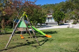 an empty swing set in a yard at Regada House in Vieira do Minho