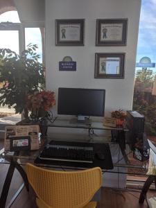 a desk with a computer monitor and a keyboard at Days Inn by Wyndham Bullhead City in Bullhead City