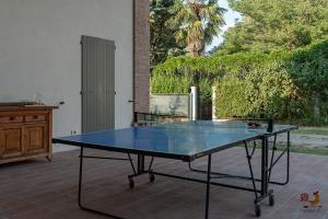 a ping pong table sitting on a patio at Casale13 in Faenza