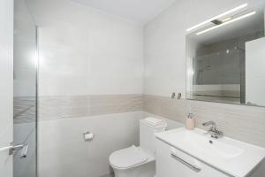 a bathroom with a toilet and a sink and a mirror at Casa Chana in Almuñécar +26 photos