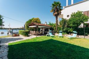 a yard with chairs and a gazebo at Kesi beach house in Volos