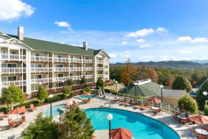 an aerial view of a hotel with a pool and tables and chairs at Sunrise Ridge Resort in Pigeon Forge