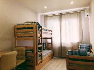 a room with two bunk beds and a window at Annet in Kharkiv