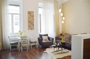 a living room with a couch and a table and chairs at Cozy App heart Budapest in Budapest