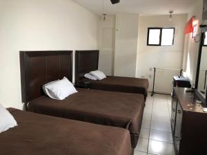 Postel nebo postele na pokoji v ubytování Hotel María Elena