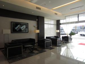 a lobby with couches and chairs in a building at D Hotel in Seri Iskandar