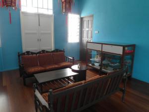a living room with a couch and a table at White Cottage in Kuching