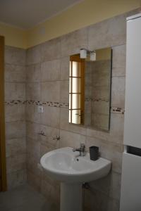 a bathroom with a sink and a mirror at CASA DEL MINATORE in Nebida