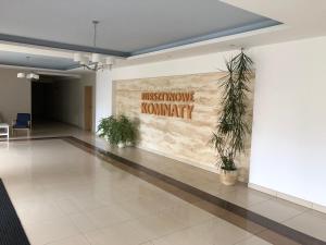 a lobby with a wall with a sign that reads must move normally at Apartament Maxim in Darłówko