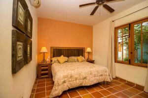 a bedroom with a bed and a ceiling fan at Casa Del Vino 2BR by Casago in Loreto +16 photos
