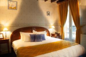 Säng eller sängar i ett rum på Hôtel Riquet