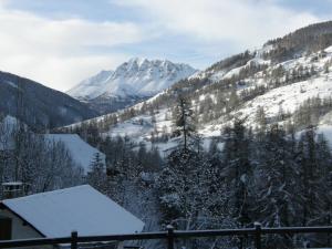 una montagna innevata con una casa in primo piano di Résidence - Gite La Mourée a Vars