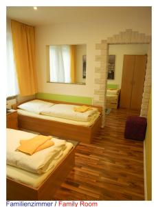A bed or beds in a room at Pension Central Nuernberg-Fuerth
