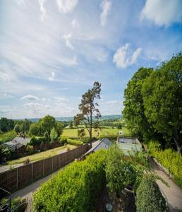 an aerial view of a garden with a fence and trees at Our beautiful large Suite room with a Double bath with Shower ensuite - It has a full Kitchen boasting stunning views over the Axe Valley - Only 3 miles from Lyme Regis, River Cottage HQ & Charmouth - Comes with free private parking in Axminster