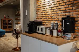 a kitchen with a counter with a brick wall at Nuan Boutique Hotel in Chiang Mai