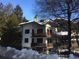 an old white house with snow on it at Ridge Line in Ponte di Legno