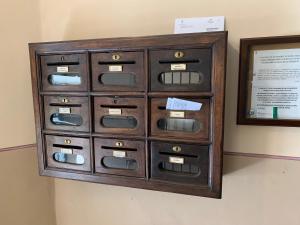 an old wooden cabinet with nine drawers on a wall at Mansarda Garibaldi 11 in Turin