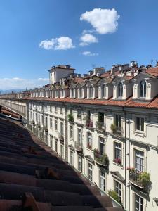 a row of white buildings with flowers on the balconies at Mansarda Garibaldi 11 in Turin