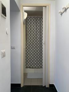 a bathroom with a walk in shower next to a door at Mansarda Garibaldi 11 in Turin