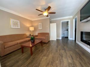a living room with a couch and a ceiling fan at Travelodge by Wyndham Santa Maria in Santa Maria