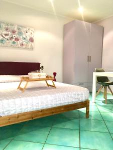 a bedroom with a bed and a table at Il Lago Riflesso in Verbania