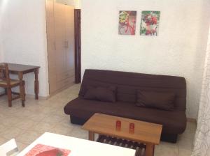 a living room with a couch and a table at Aialion studios & apartments - Steve Apartments in Rhodes Town