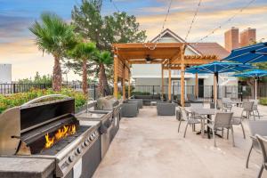 a patio with a fire pit and tables and chairs at Chase Suite El Paso in El Paso