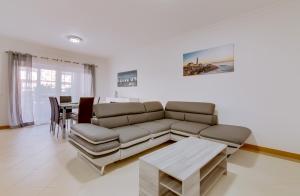 a living room with a couch and a table at Victoria Boulevard - Vasco da Gama - Vilamoura in Vilamoura