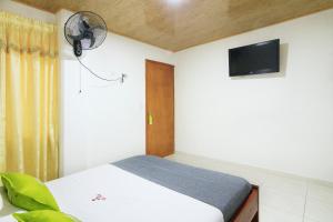 a bedroom with a bed and a flat screen tv at Hotel El Rubí in Bucaramanga