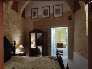 1 dormitorio con cama y espejo en Amelia's House of Character, en Cospicua