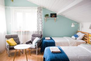 a bedroom with two beds and a table and chairs at RowerowyFun in Nowy Sącz